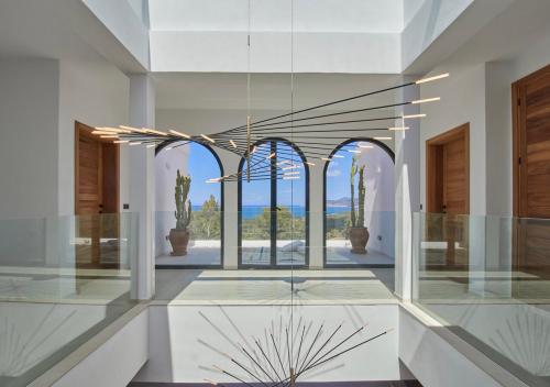 a glass lobby with a view of the ocean at Villa La Residence Ibiza in Sant Josep de sa Talaia
