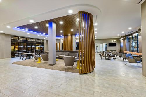 a lobby with tables and chairs in a building at SpringHill Suites by Marriott Colorado Springs Downtown in Colorado Springs