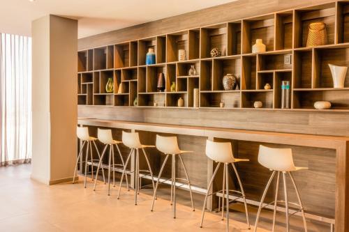 a bar with a row of stools in a room at Fairfield Inn & Suites by Marriott Mexico City Vallejo in Mexico City