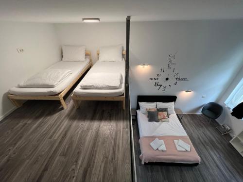 two bunk beds in a room with wooden floors at Absolutum Apartments in Ljubljana