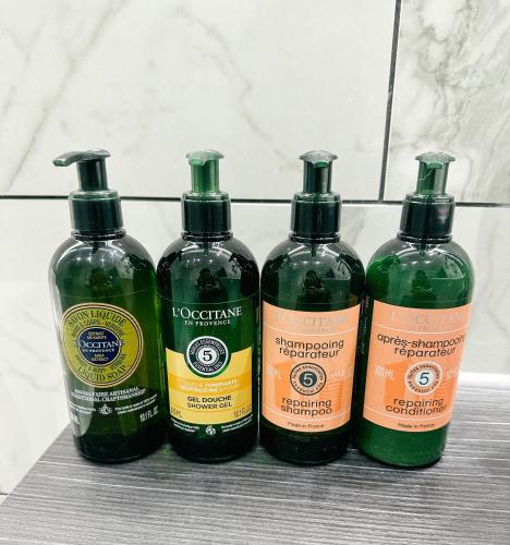 a group of four bottles of liquid sitting on a counter at Watersmeet Hotel in Woolacombe
