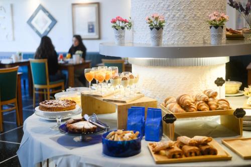 a table filled with lots of different types of pastries at Art Hotel Milano in Prato