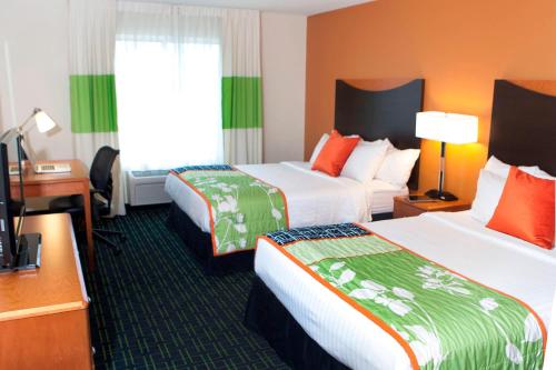 a hotel room with two beds and a desk at Fairfield Inn & Suites by Marriott Memphis East Galleria in Memphis