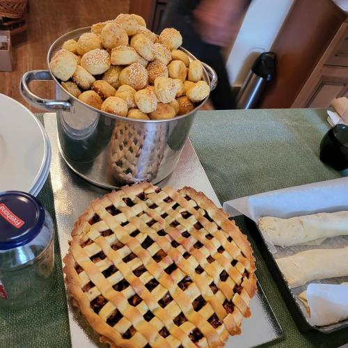 a table with a pie and a bucket of snacks at Napvirág-Ház in Zsira