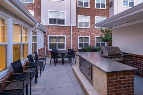 an outdoor patio with tables and chairs and a grill at Residence Inn by Marriott Denver Golden/Red Rocks in Golden