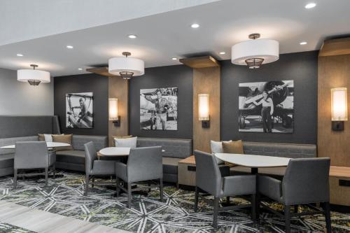 a restaurant with tables and chairs and pictures on the walls at Residence Inn by Marriott Lancaster Palmdale in Lancaster