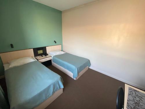 a hotel room with two beds in a room at Ulpan Mini Hotel in Astana