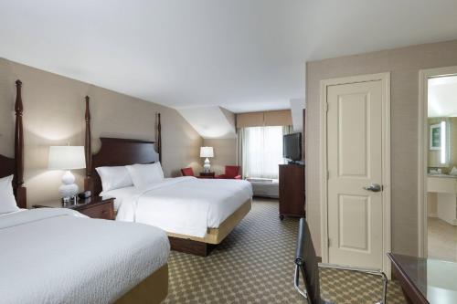 a hotel room with two beds and a television at Fairfield Inn by Marriott Boston Sudbury in Sudbury