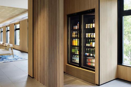 a room with a refrigerator with drinks in it at Fairfield by Marriott Nara Tenri Yamanobenomichi in Tenri
