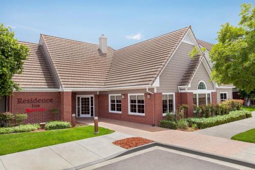 a home with a red brick at Residence Inn By Marriott Vacaville in Vacaville