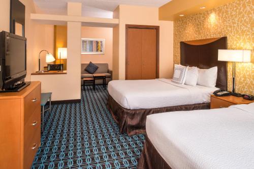 a hotel room with two beds and a flat screen tv at Fairfield Inn and Suites by Marriott San Antonio Northeast / Schertz / RAFB in Schertz