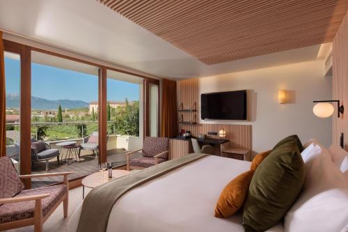 a hotel room with a bed and a large window at Hotel Marqués de Riscal, a Luxury Collection Hotel, Elciego in Elciego