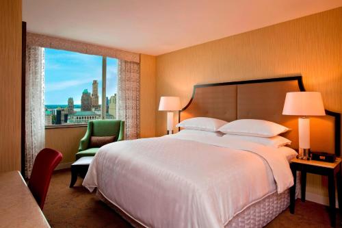 a hotel room with a large bed and a window at Sheraton Brooklyn New York in Brooklyn