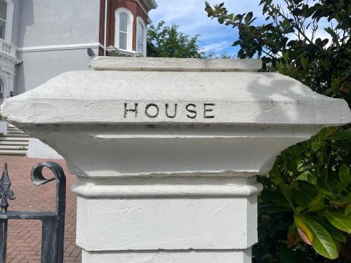 a white mailbox with the word house written on it at Beach House 3 Bed Penthouse Apartment in Southport