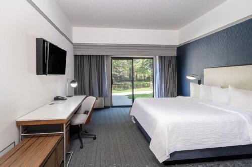 a hotel room with a bed and a desk at Courtyard by Marriott Colorado Springs South in Colorado Springs