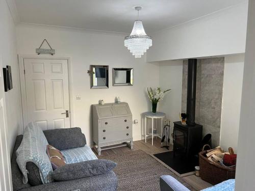 a living room with a couch and a dresser at Lilly’s Cottage, Filey, Sleeps 8 in Filey
