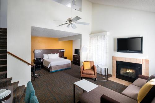 a hotel room with a bed and a fireplace at Residence Inn by Marriott Long Beach in Long Beach