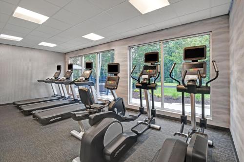 a gym with a row of treadmills and ellipticals at Fairfield by Marriott Inn & Suites Mansfield in Mansfield