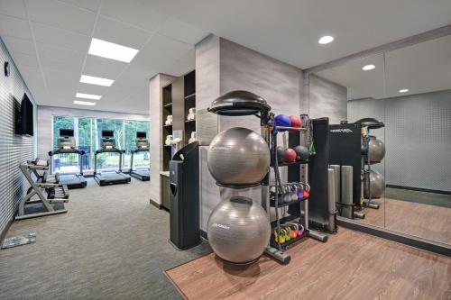 a fitness room with a bunch of equipment in it at Fairfield by Marriott Inn & Suites Mansfield in Mansfield