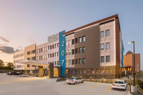 a building with two cars parked in a parking lot at Fairfield Inn & Suites by Marriott Des Moines Downtown in Des Moines