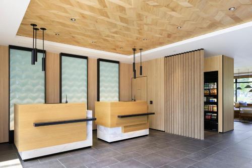 a kitchen with wooden cabinets and a ceiling with windows at Fairfield by Marriott Hokkaido Naganuma in Naganuma