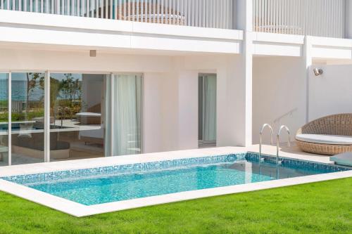 a swimming pool in the backyard of a house at IRAPH SUI, a Luxury Collection Hotel, Miyako Okinawa in Miyako Island