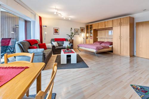 a living room with a couch and a table at Terrassenpark Schonach App 161 in Schonach