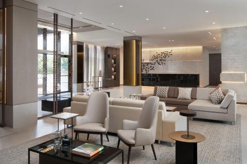 a living room with a couch and chairs at AC Hotel by Marriott Punta Cana in Punta Cana