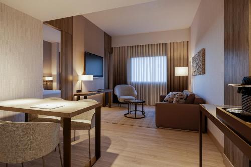 a hotel room with a living room at AC Hotel by Marriott Punta Cana in Punta Cana