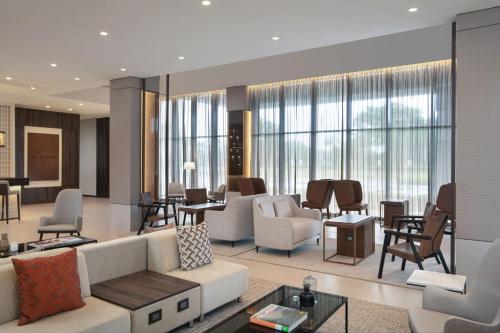 a living room with a couch and chairs at AC Hotel by Marriott Punta Cana in Punta Cana