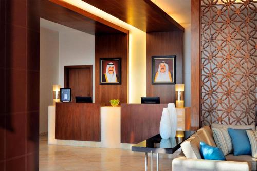 a lobby with a couch and a reception desk at Residence Inn by Marriott Kuwait City in Kuwait