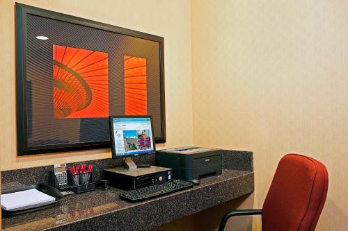 a desk with a computer on top of a room at Residence Inn Lansing West in Delta Center Township