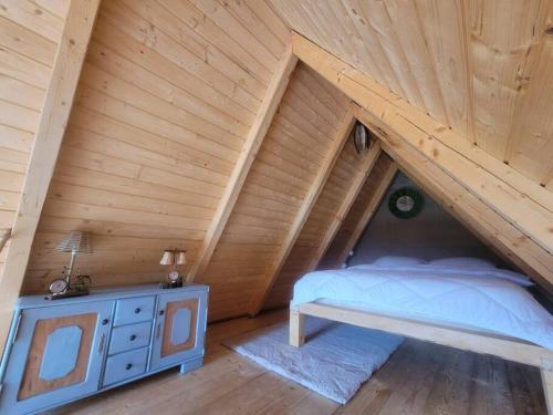 ein Schlafzimmer mit einem Bett und einer Holzdecke in der Unterkunft Waterfall A Frame, Maramures in Baia Mare