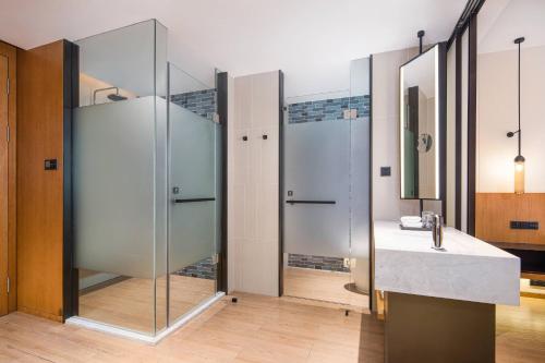 a bathroom with a glass shower and a sink at Fairfield by Marriott Foshan Nanhai in Foshan
