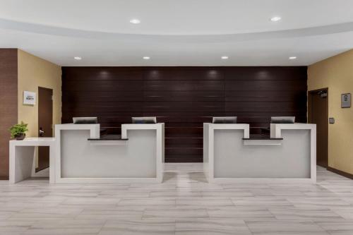 a lobby with two white desks and a wooden wall at Delta Hotels by Marriott Somerset in Somerset
