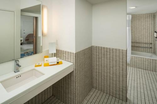 a bathroom with a sink and a shower at Royal Palm South Beach Miami, a Tribute Portfolio Resort in Miami Beach