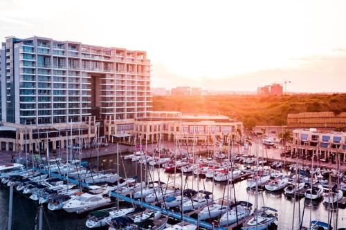 a group of boats docked in a marina next to a building at The Ritz-Carlton, Herzliya in Herzelia 