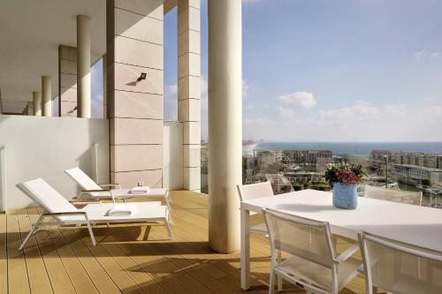 a balcony with a table and chairs on a building at The Ritz-Carlton, Herzliya in Herzelia 