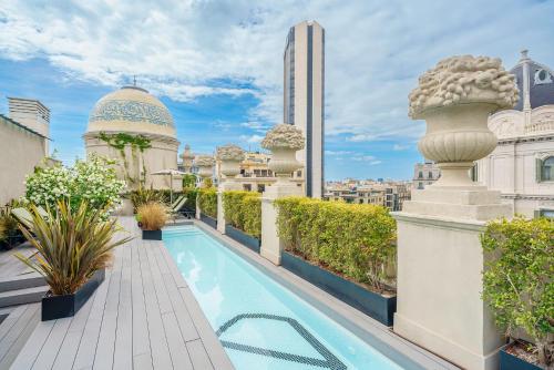 a balcony with a swimming pool on top of a building at Casagrand Luxury Suites in Barcelona
