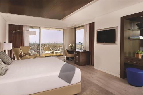 a hotel room with a large bed and a television at The Ritz-Carlton, Herzliya in Herzelia 
