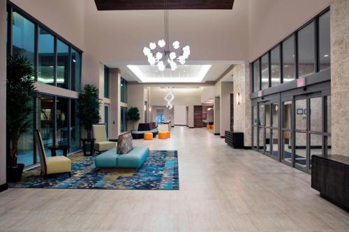 a lobby with a blue couch and chairs in a building at TownePlace Suites by Marriott Orlando Theme Parks Lake Buena Vista in Orlando