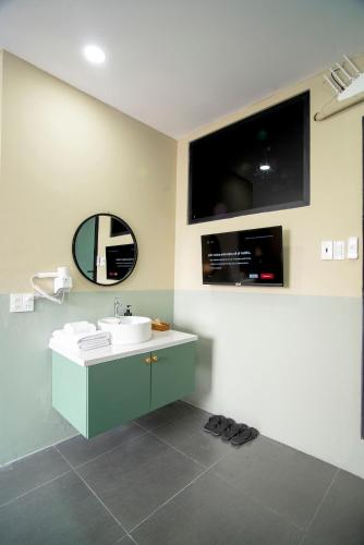 a bathroom with a sink and a mirror at SAZI BEN THANH Hotel HCM in Ho Chi Minh City