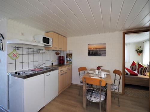 a kitchen and dining room with a table and a room at Schüler, Wolfgang in Zingst