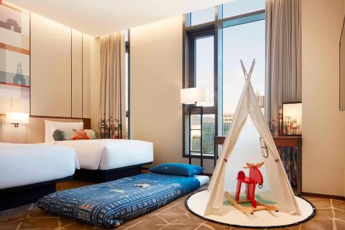 a bedroom with a bed with a tent in it at Aloft Seoul Myeongdong in Seoul