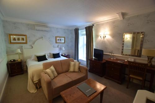 a hotel room with a bed and a couch at Watersmeet Hotel in Woolacombe