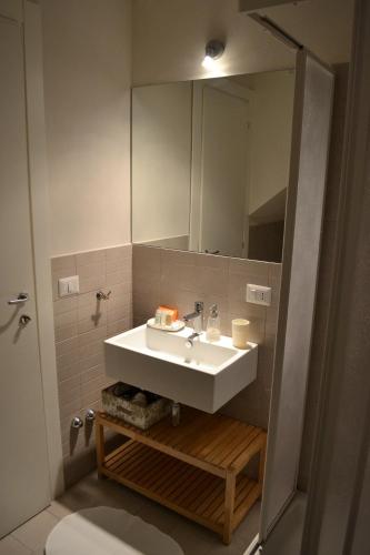 a bathroom with a white sink and a mirror at Monaciello in Naples
