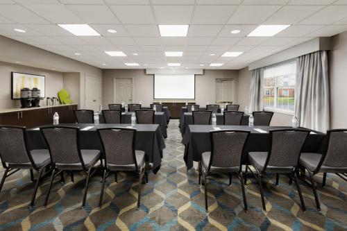 a conference room with tables and chairs and a whiteboard at Residence Inn Saddle River in Saddle River