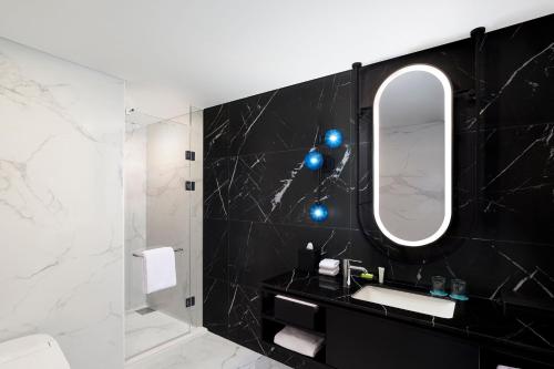 a bathroom with a sink and a mirror at Le Meridien Seoul Myeongdong in Seoul