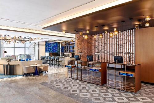a lobby with a bar with chairs and a table at Le Méridien Seoul Myeongdong in Seoul