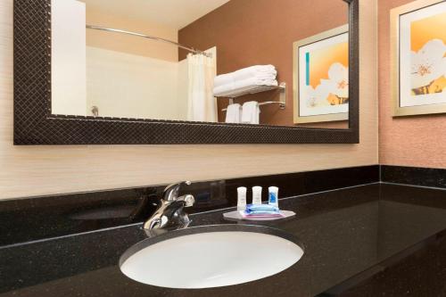 a bathroom with a sink and a mirror at Fairfield Inn & Suites Midland in Midland